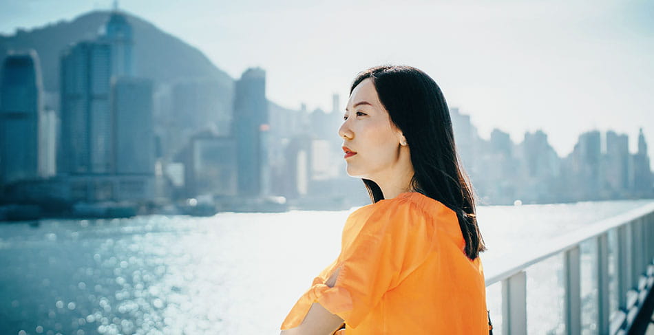 Woman at the water with skyline