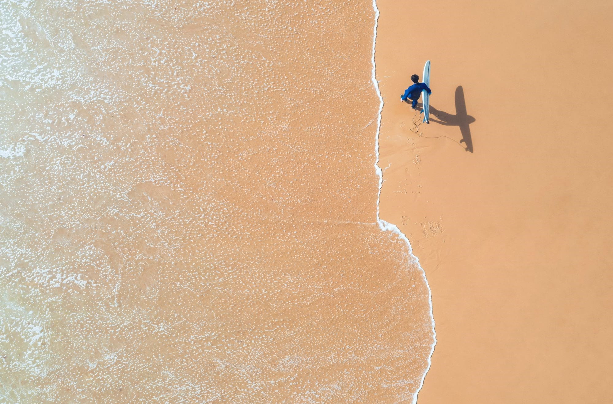 Surfer on beach from above